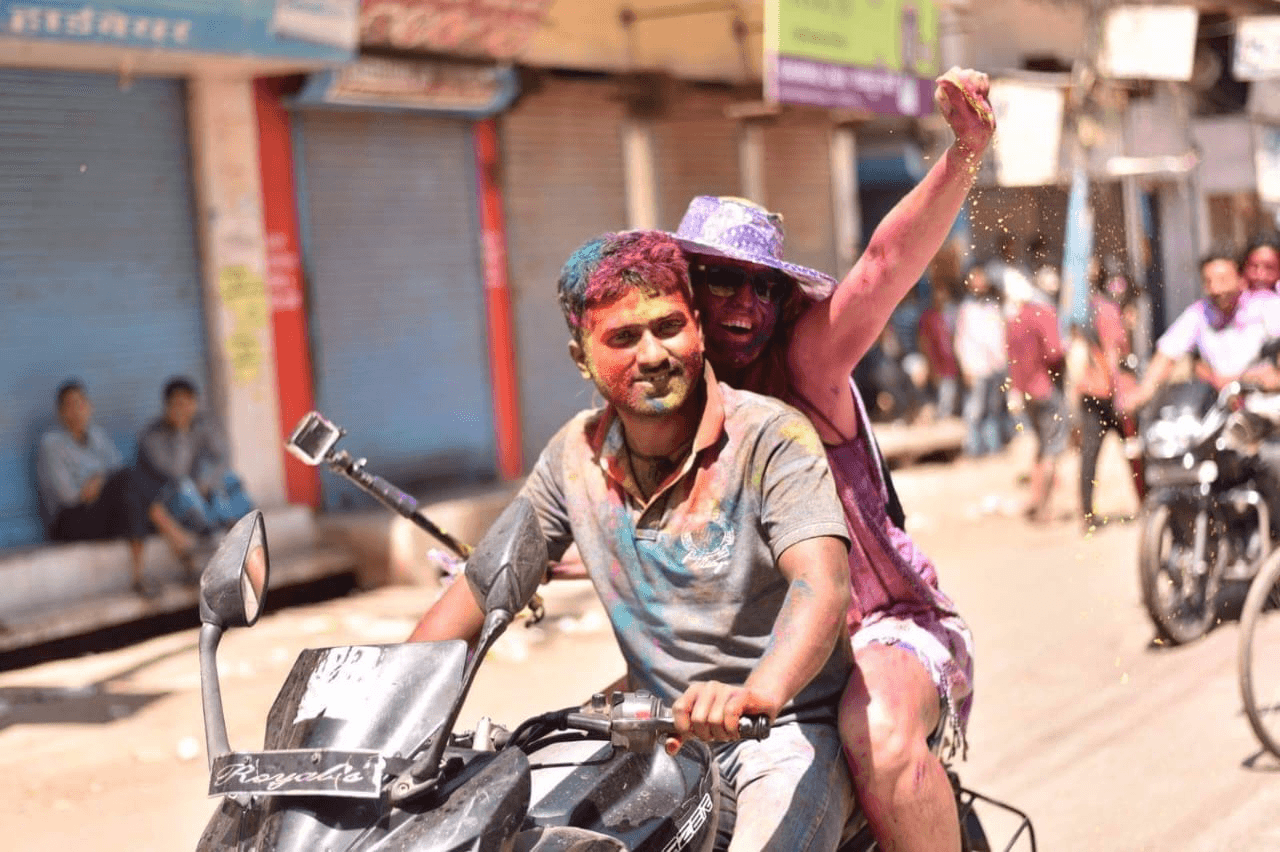 Travelers at a temple with colorful decorations